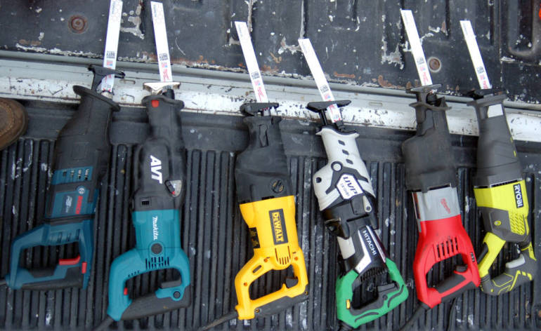 reciprocating saws (sawzalls) in a line, waiting to be tested.